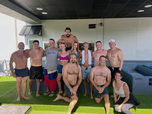 A corporate group photographed together in the plunge room after a contrast session
